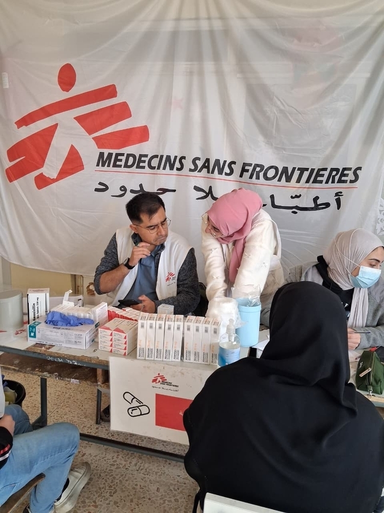 MSF employees giving out medicine